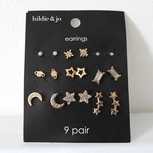 Eight pairs of gold space-themed stud earrings